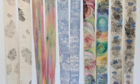 Detail of hanging calico swags, printed, painted and stitched with feathers