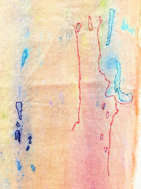 Red and blue stitched outlines tracing watercolour marks on calico